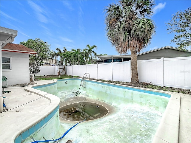 view of swimming pool with a jacuzzi