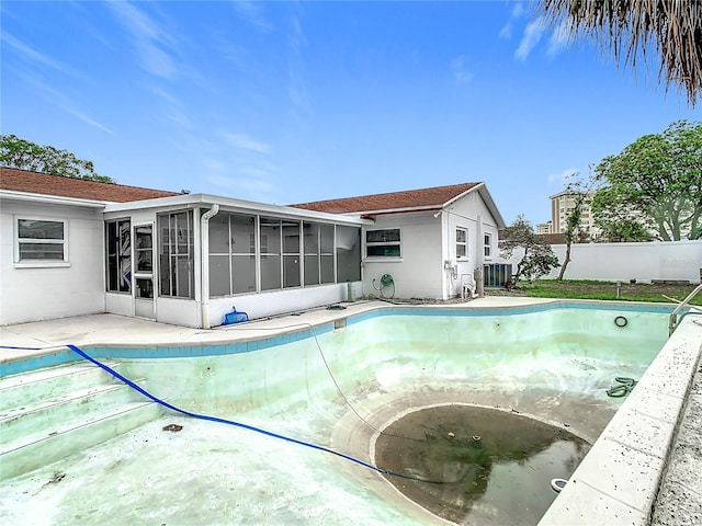 view of swimming pool featuring a sunroom