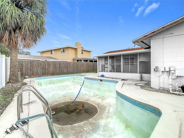 view of swimming pool with a sunroom