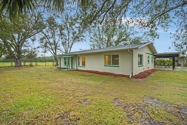 exterior space featuring a carport and a yard