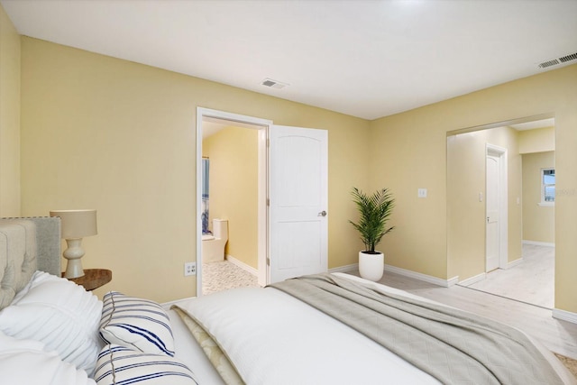 carpeted bedroom featuring ensuite bathroom