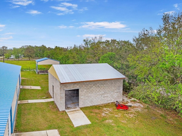 view of outdoor structure featuring a lawn