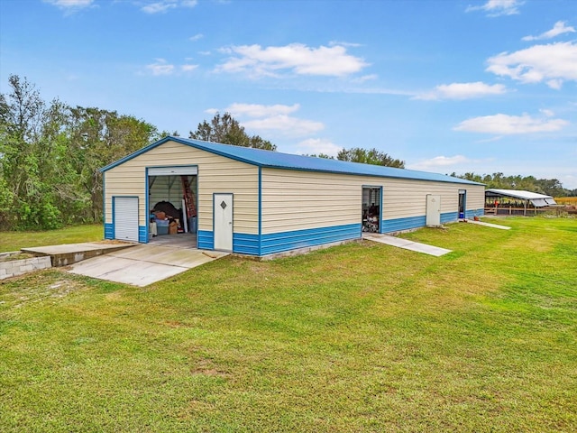 view of outdoor structure with a yard and a garage