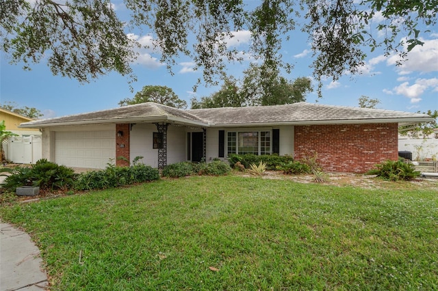 ranch-style home with a front lawn and a garage