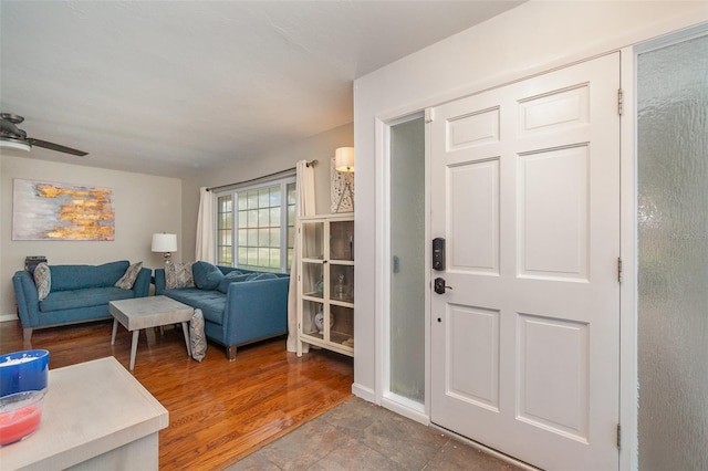 living room featuring wood-type flooring and ceiling fan