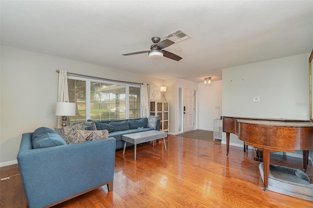 living room featuring hardwood / wood-style flooring and ceiling fan