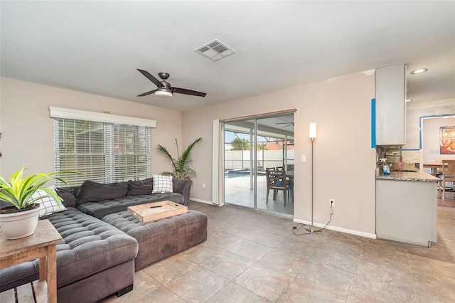 living room featuring ceiling fan and light tile patterned flooring