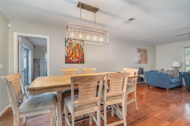 dining space with hardwood / wood-style floors and ceiling fan