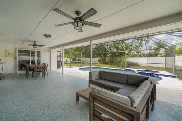 view of patio with glass enclosure and an in ground hot tub