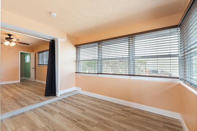 spare room with ceiling fan and light hardwood / wood-style floors