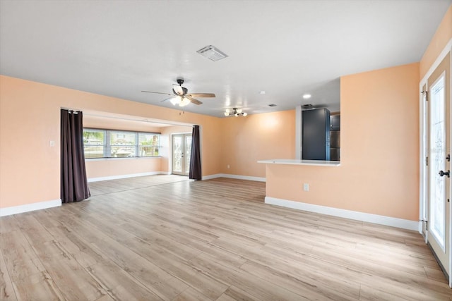 unfurnished living room featuring ceiling fan and light wood-type flooring