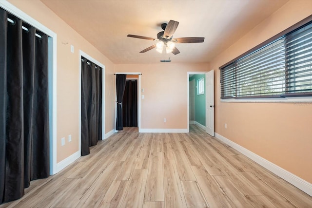 unfurnished bedroom featuring light wood-type flooring and ceiling fan