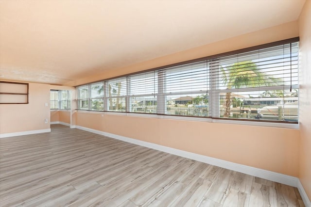 unfurnished room with light wood-type flooring