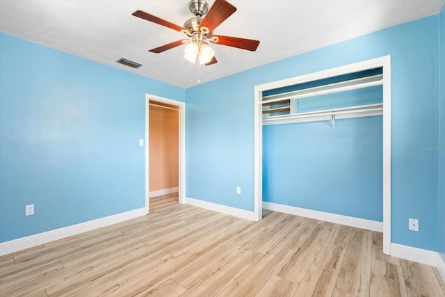 unfurnished bedroom featuring ceiling fan, a closet, and light hardwood / wood-style flooring