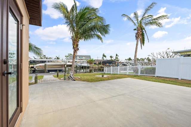 view of patio / terrace featuring a water view and a boat dock