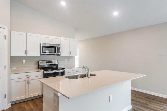 kitchen featuring appliances with stainless steel finishes, white cabinets, a sink, and light countertops