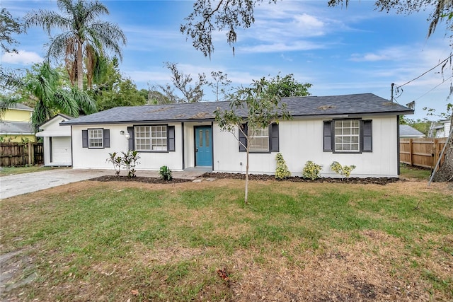 ranch-style home with a front yard and a garage