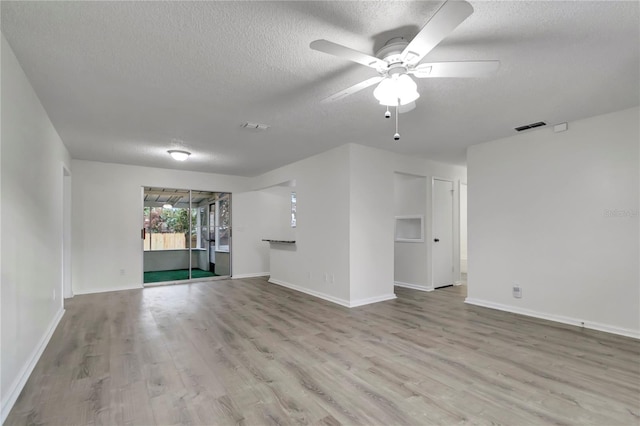 unfurnished living room with ceiling fan, a textured ceiling, and light hardwood / wood-style flooring