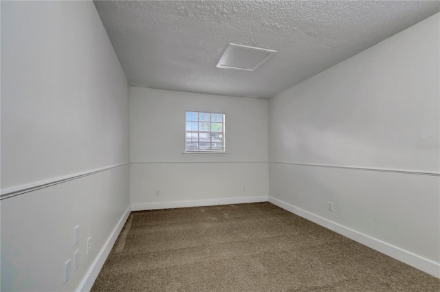 empty room featuring carpet floors and a textured ceiling