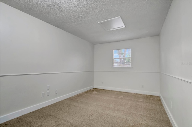 carpeted empty room with a textured ceiling