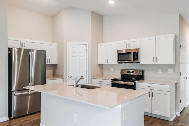 kitchen with stainless steel appliances, light countertops, white cabinetry, high vaulted ceiling, and a sink