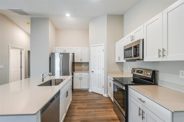 kitchen with dark wood-style flooring, a sink, visible vents, light countertops, and appliances with stainless steel finishes