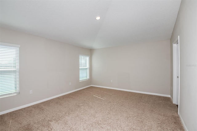 unfurnished room featuring lofted ceiling, recessed lighting, carpet, and baseboards