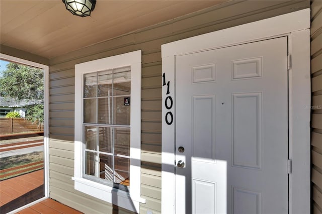 doorway to property featuring covered porch