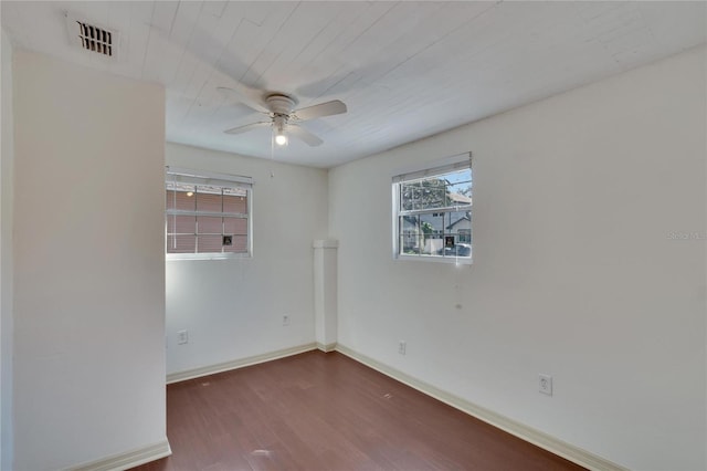 empty room featuring ceiling fan and dark hardwood / wood-style flooring