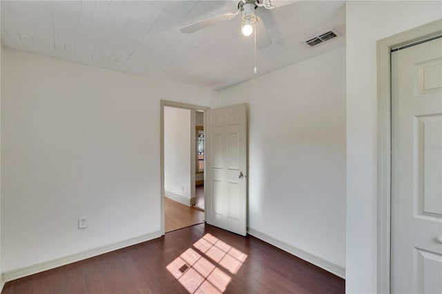 unfurnished room with ceiling fan and dark hardwood / wood-style flooring