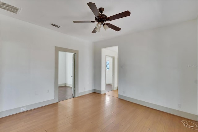 empty room with ceiling fan and light wood-type flooring