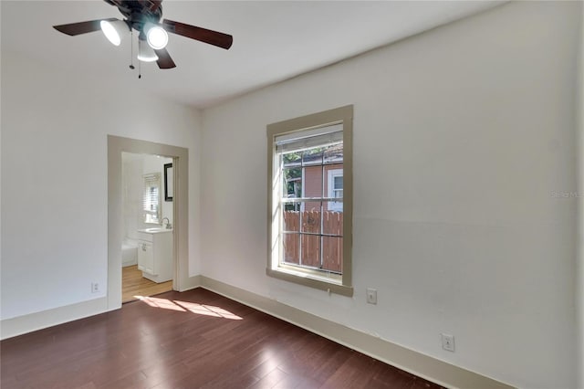 unfurnished room with hardwood / wood-style flooring, ceiling fan, and sink