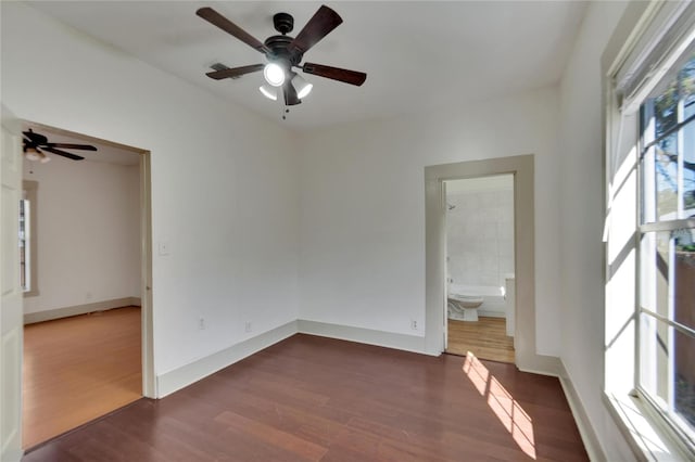 spare room featuring ceiling fan and dark wood-type flooring