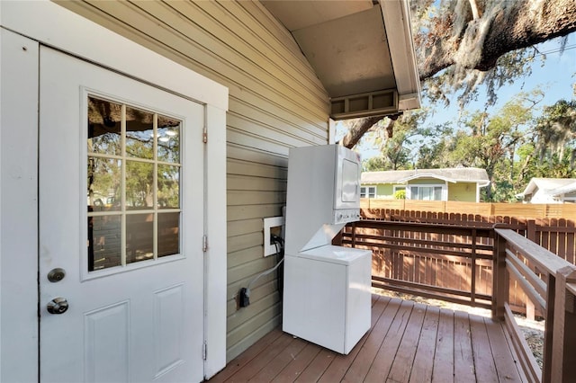 deck with stacked washer and clothes dryer