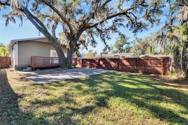 view of yard featuring a patio area and a wooden deck