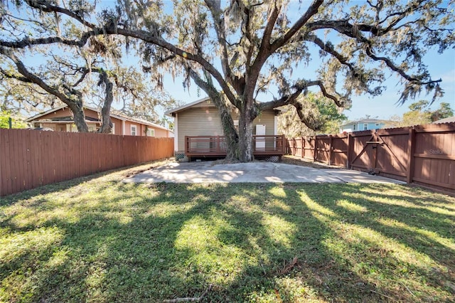 view of yard featuring a patio area and a wooden deck