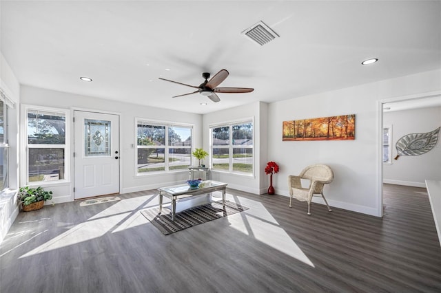 interior space with ceiling fan and dark hardwood / wood-style floors