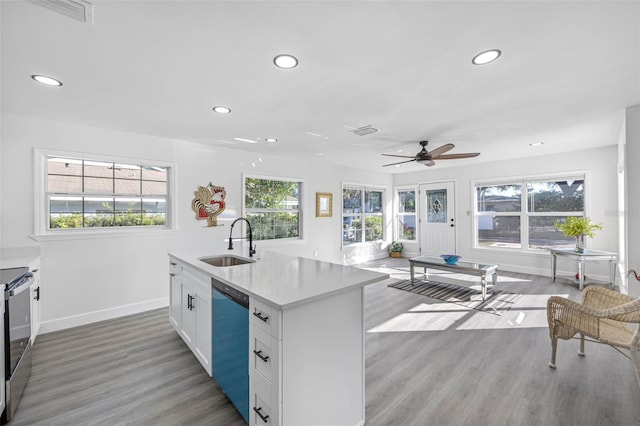 kitchen with white cabinets, sink, light hardwood / wood-style flooring, ceiling fan, and stainless steel appliances