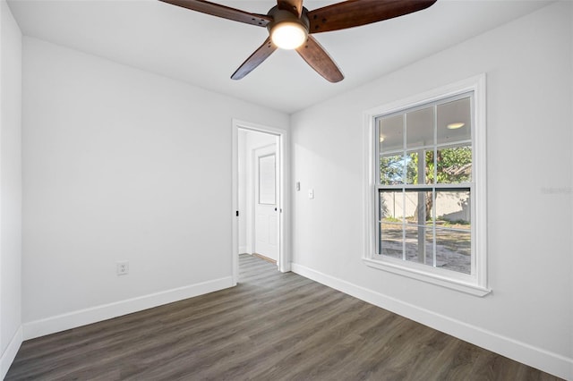 spare room featuring dark hardwood / wood-style floors and ceiling fan