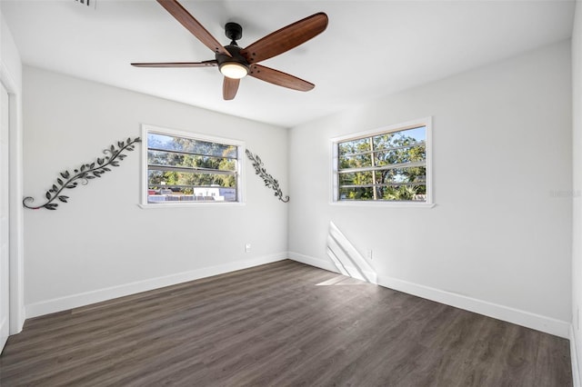 unfurnished room featuring ceiling fan and dark wood-type flooring