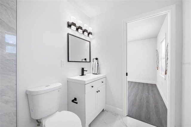 bathroom featuring hardwood / wood-style flooring, vanity, and toilet