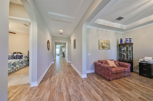 corridor featuring light hardwood / wood-style flooring and ornamental molding