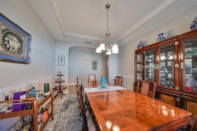13230 Fawn Lily Dr, Riverview, FL 33579 - dining room with arched walkways, a chandelier, and a tray ceiling