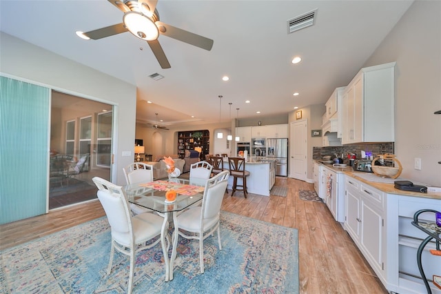 dining room featuring light wood-type flooring and ceiling fan