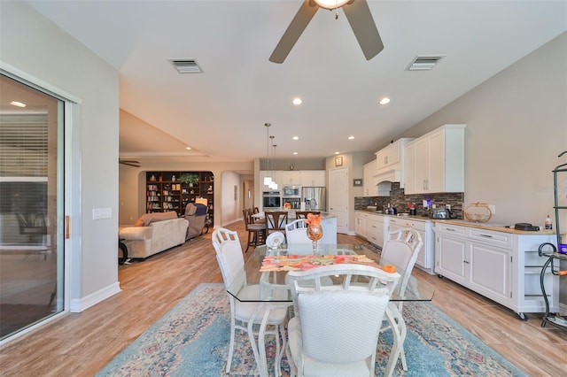 dining area featuring ceiling fan and light hardwood / wood-style flooring