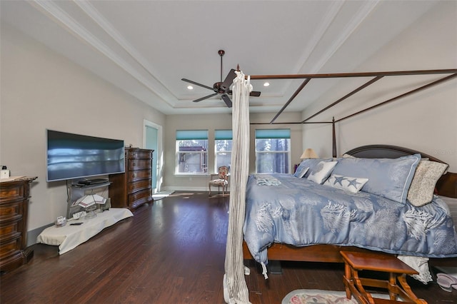 bedroom featuring wood-type flooring, a raised ceiling, ceiling fan, and crown molding