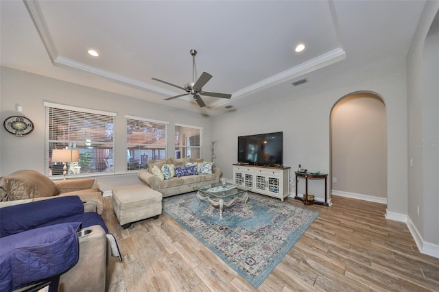13230 Fawn Lily Dr, Riverview, FL 33579 - living room with a raised ceiling, arched walkways, a ceiling fan, wood finished floors, and ornamental molding