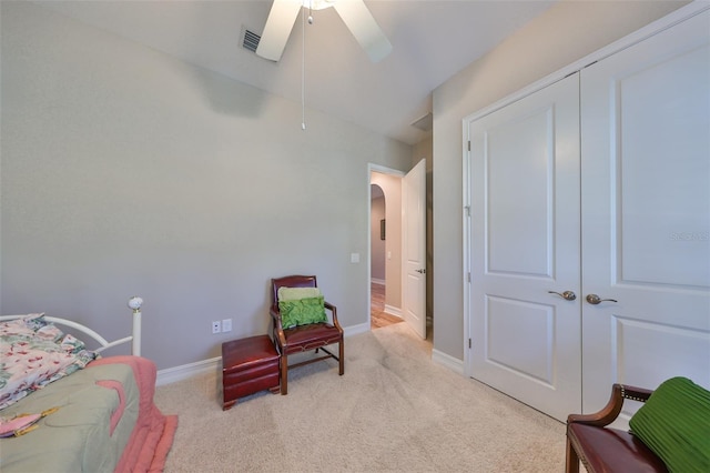 bedroom with ceiling fan, a closet, and light colored carpet