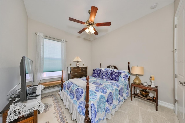 bedroom with ceiling fan and light carpet