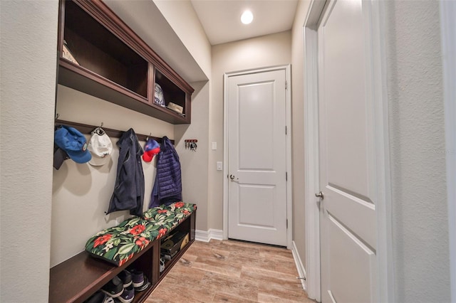 mudroom with light hardwood / wood-style flooring